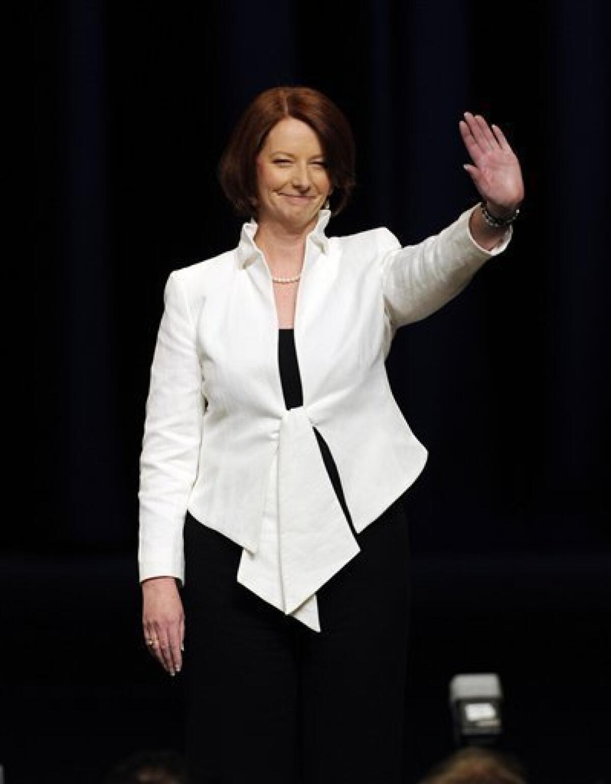 Australian Prime Minister Julia Gillard, leader of the Australian Labor Party, waves to the crowd after her post election speech in Melbourne, Saturday, Aug. 21, 2010. (AP Photo/Andrew Brownbill)