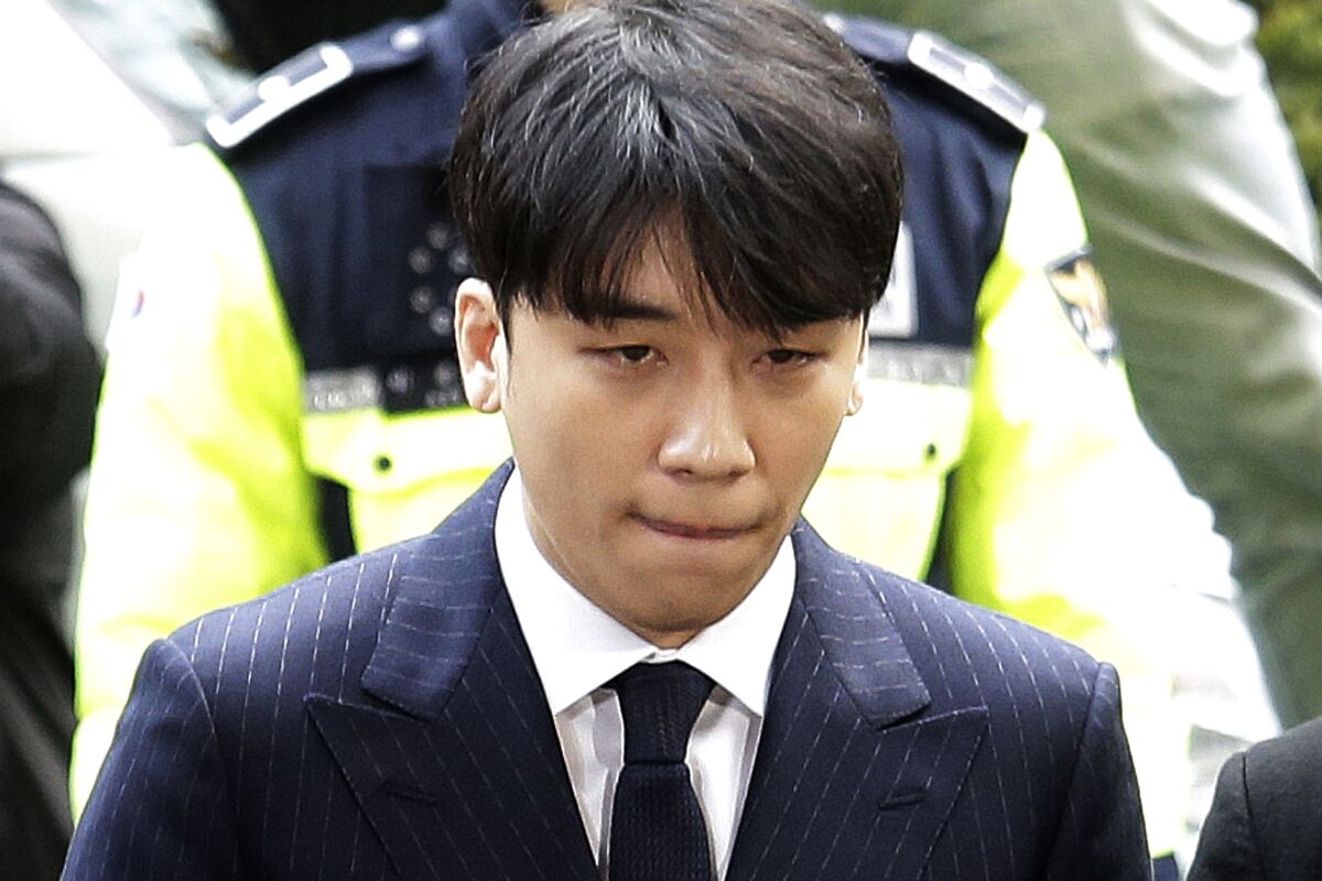 FILE - In this March 14, 2019, file photo, Seungri, a former member of a popular K-pop boy band Big Bang, arrives at the Seoul Metropolitan Police Agency in Seoul, South Korea. A South Korean military court sentenced disgraced K-pop star Seungri to three years in prison on Thursday, Aug. 12, 2021, for crimes including providing prostitutes to foreign businessmen. (AP Photo/Ahn Young-joon, File)