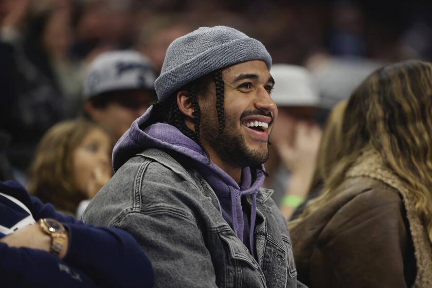 Former Vikings linebacker Eric Kendricks smiles while watching an NBA game in Minneapolis.