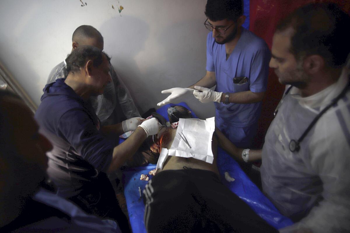 Palestinian medics treating wounded man in Gaza