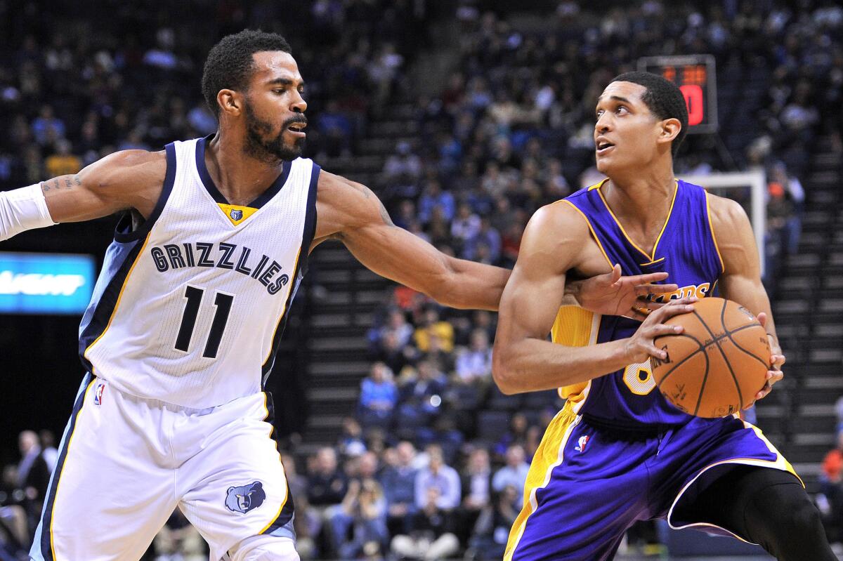 Grizzlies point guard Mike Conley tries to steal the ball from Lakers point guard Jordan Clarkson in the first half.