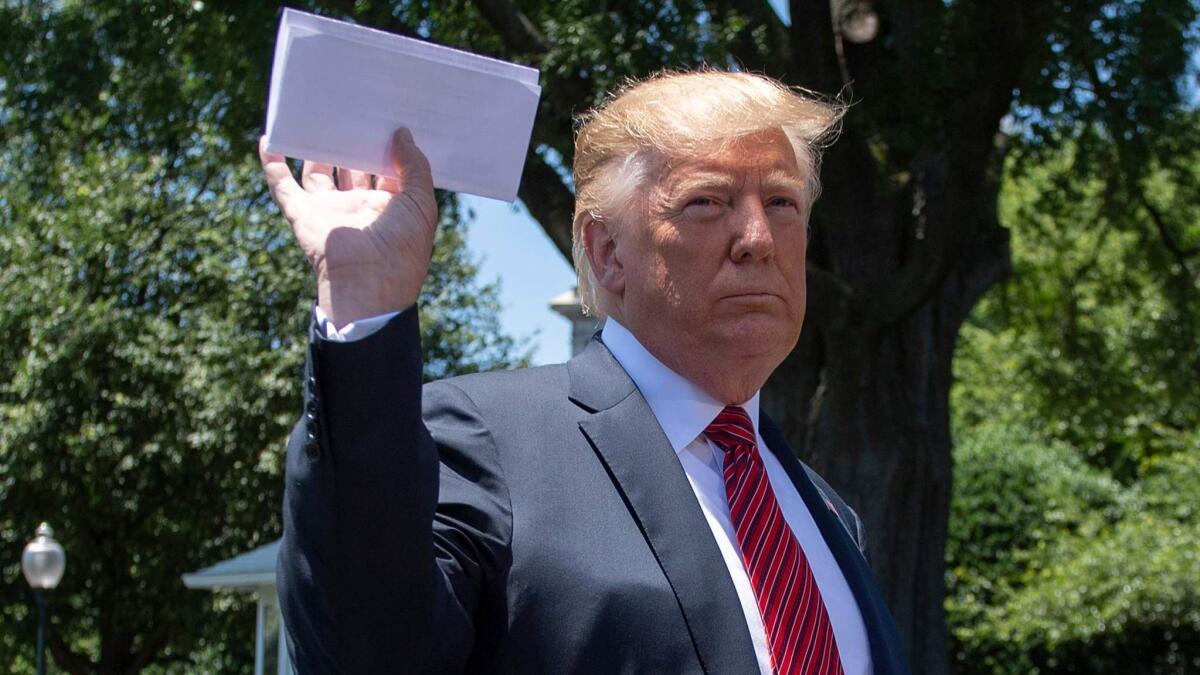 President Trump with a piece of paper that he claims is his deal with Mexico. He did not show the contents of the paper to reporters.