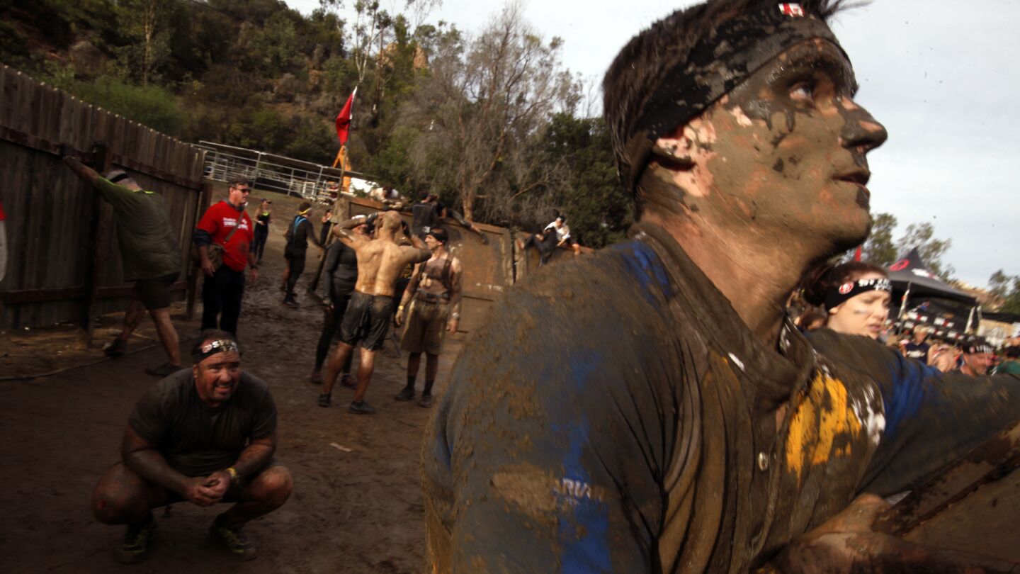 Alex Rylance, right, looks up as he begins to climb the 'slip wall' as fellow competitor John Mulcahy, left, catches his breath before embarking up the wall during the Spartan Race at Calamigos Ranch in Malibu on Dec. 7, 2014.