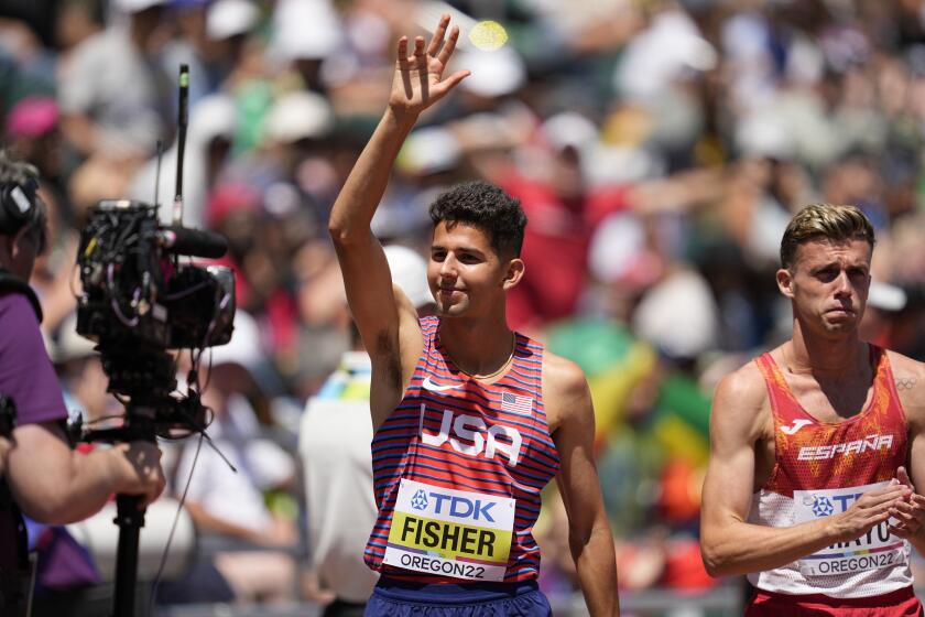 Grant Fisher, of the United States, waves ahead of the men's 10000-meter run final at the World Athletics Championships on Sunday, July 17, 2022, in Eugene, Ore. (AP Photo/Ashley Landis)