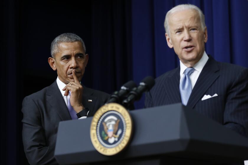 FILE - In this Dec. 13, 2016, file photo, President Barack Obama listens as Vice President Joe Biden speaks in the South Court Auditorium in the Eisenhower Executive Office Building on the White House complex in Washington. Biden is getting some help from Obama as he looks to fill his campaign coffers and unify the Democratic party ahead of the November election. Obama and Biden will appear together Tuesday, June 23, for a “virtual grassroots fundraiser,” the former vice president announced on Twitter. (AP Photo/Carolyn Kaster, File)