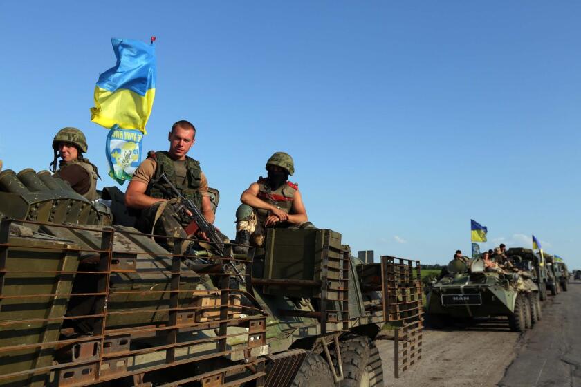 Ukrainian servicemen on patrol Friday near the eastern Ukrainian city of Slovyansk, which government troops liberated from separatist rebels last weekend.