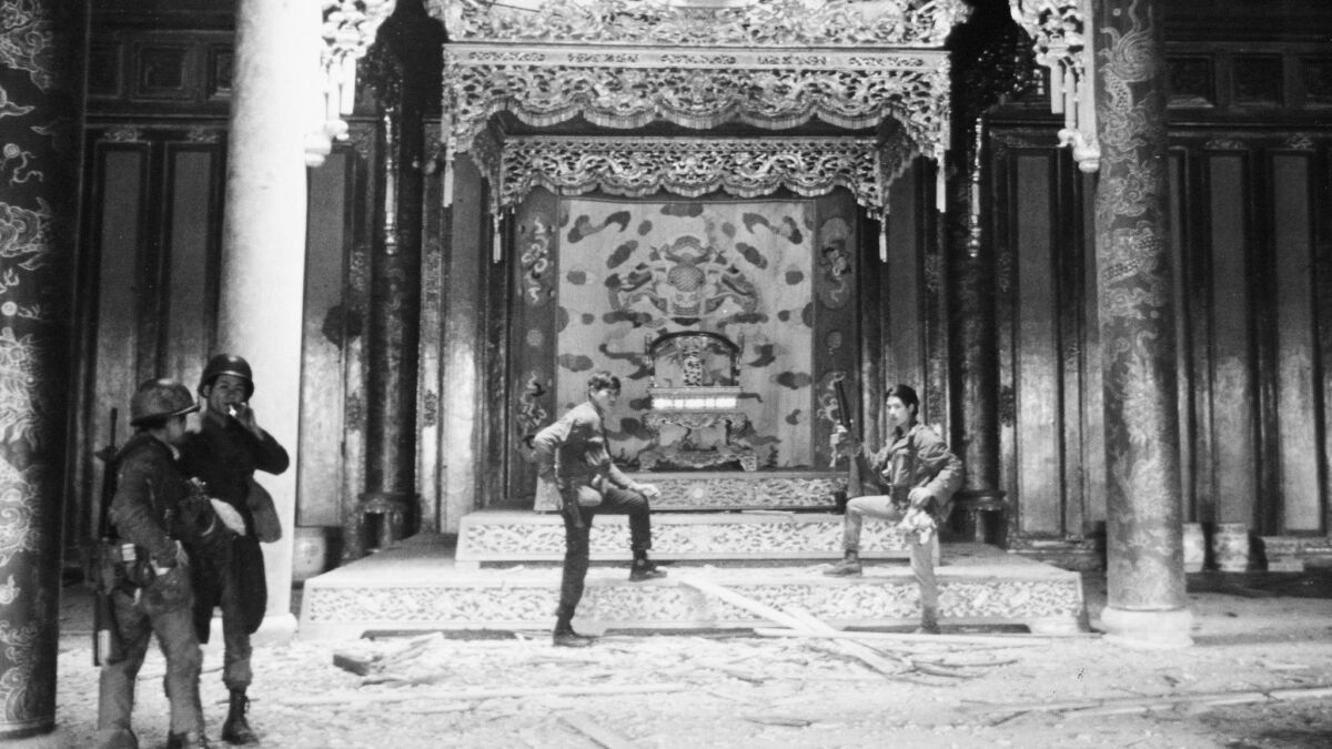 Vietnamese soldiers pose in victory in the ornate throne room of the Imperial Palace in the Citadel of Hue, Feb. 26, 1968.