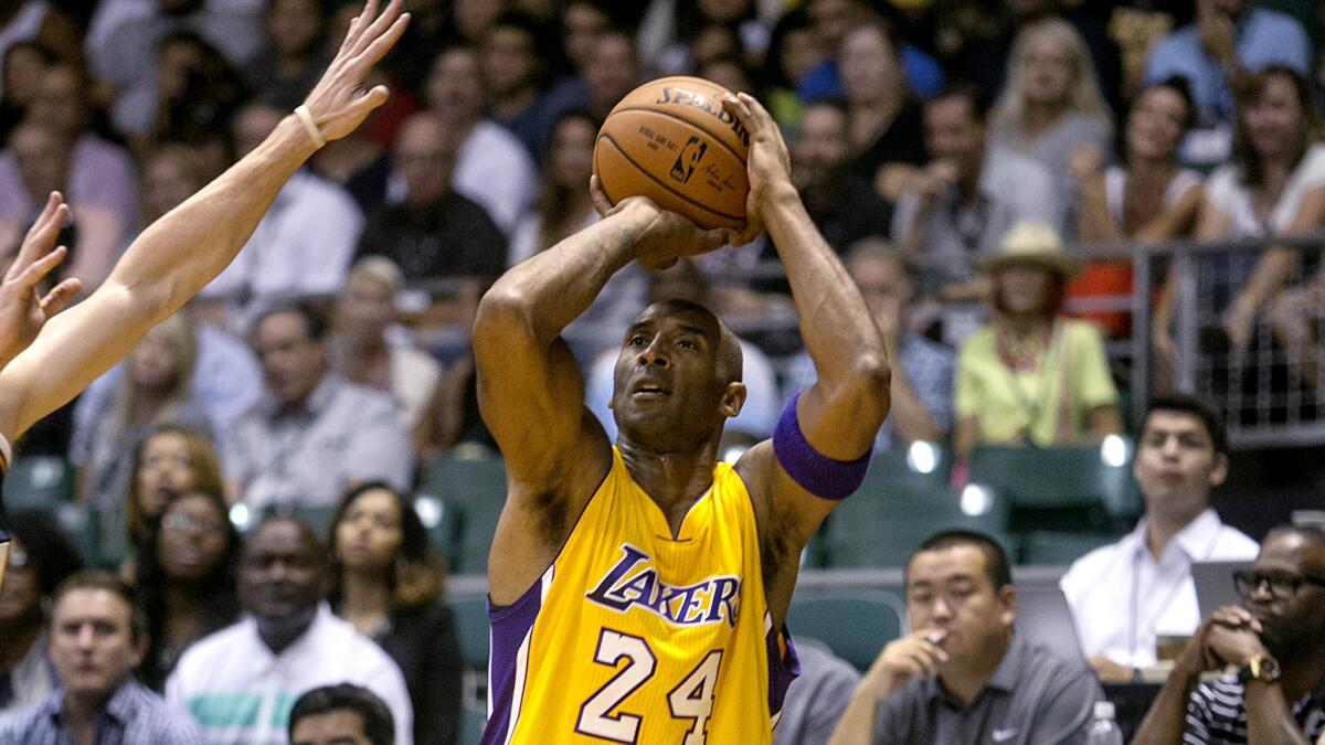 Lakers guard Kobe Bryant (24) attempts a three-point shot against the Jazz in the first quarter of their exhibition game Sunday night in Honolulu.