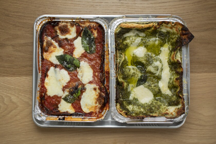 Two trays with cheese and sauce. The left has red sauce and the right green 