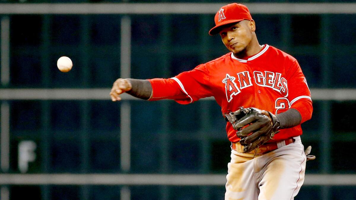 Angels shorstop Erick Aybar, making a throw during a July 29 game at Houston, is out of the lineup Friday for the second straight game because of a back injury.