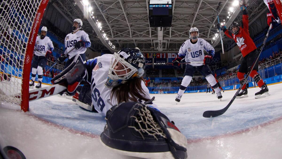 Canada's Meghan Agosta gets the puck past U.S. goaltender Madeline Rooney during a preliminary-round match between the U.S. and Canada at the Pyeongchang Winter Olympics on Feb. 15.