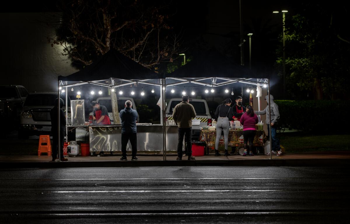 At night, people stay under illuminated tents.