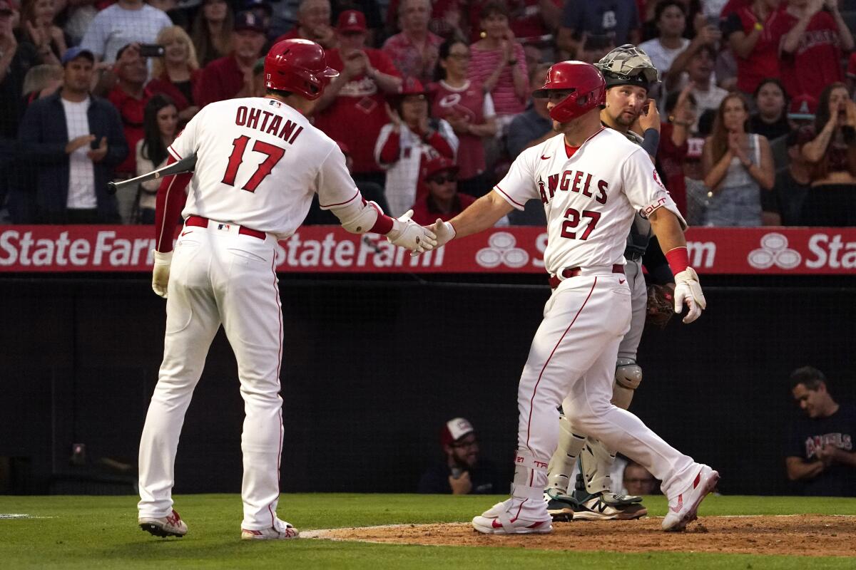 The Angels' Mike Trout is congratulated by Shohei Ohtani after hitting a solo home run June 24, 2022.