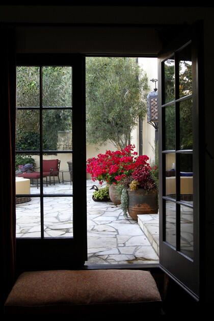 French doors in the living room open to the bubbling of the quatrefoil fountain and a view of the hot pink bougainvillea. For the full article on this garden, go to our L.A. at Home blog. More profiles: Southern California homes and gardens