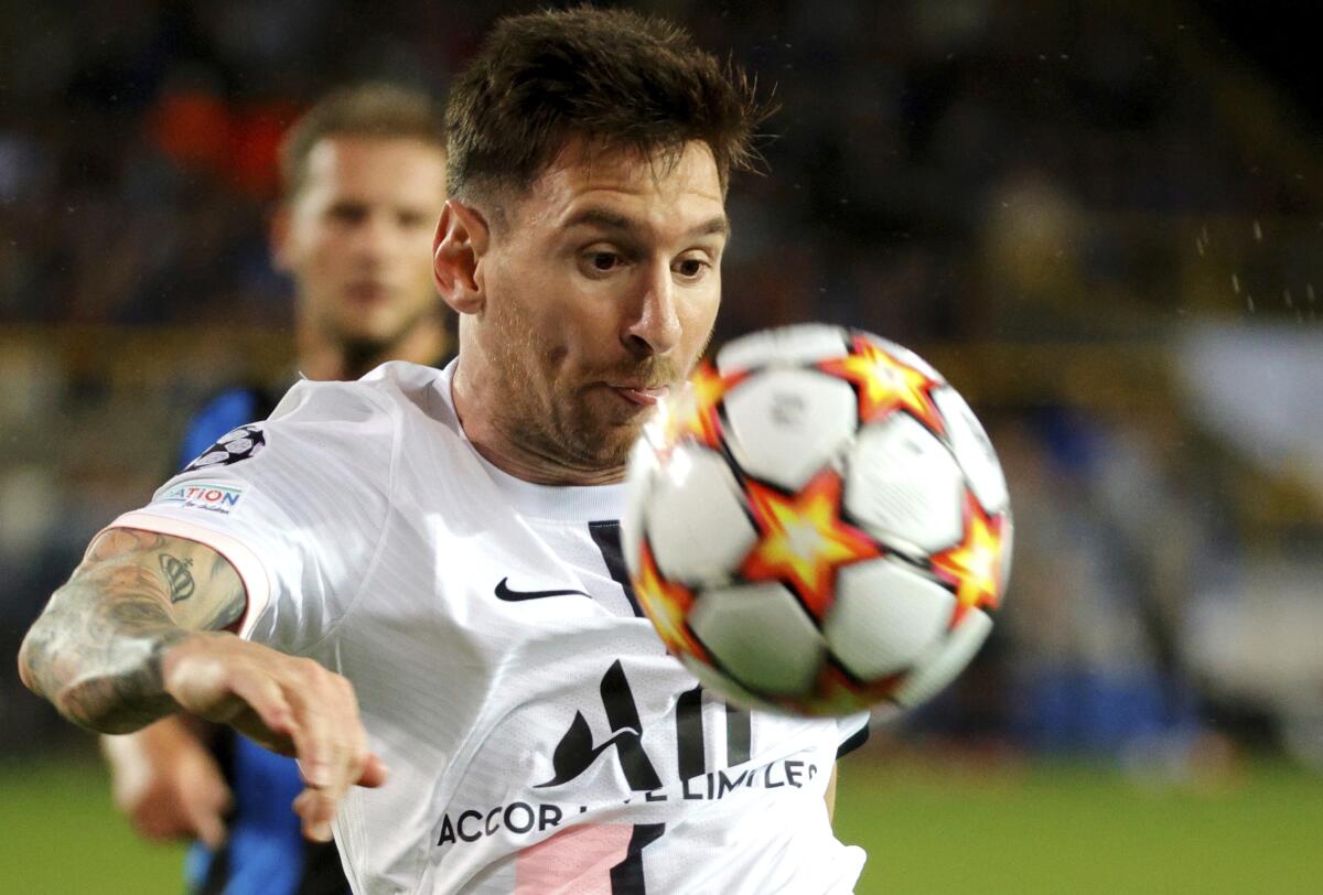 PSG's Lionel Messi fights for control of the ball during the Champions League Group A s 