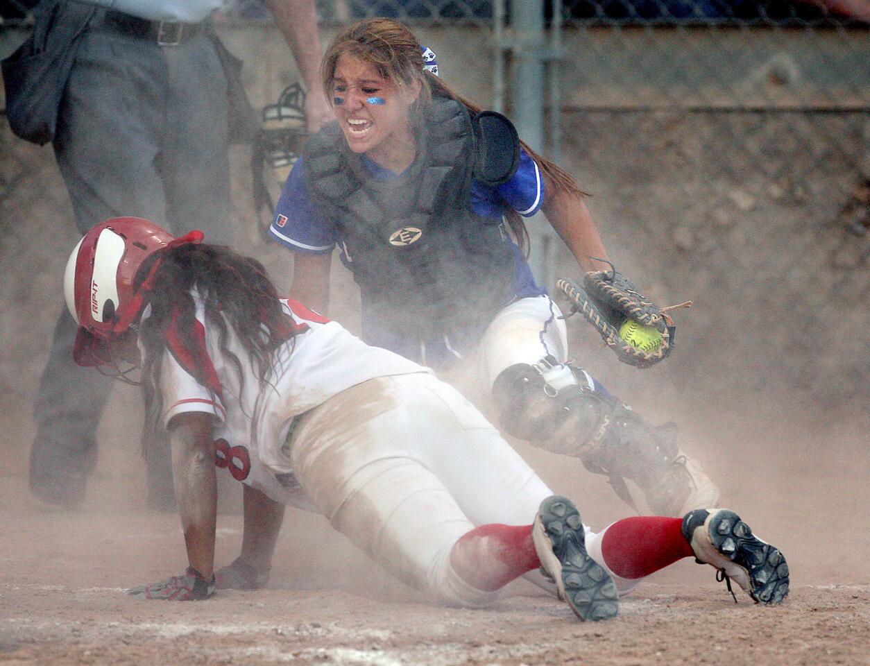 Burbank catcher Bridgette Pisa reacts after a collision at home plate with Burroughs' Michelle Santiago during a game on Thursday, April 24, 2014. (Roger Wilson/Staff Photographer)
