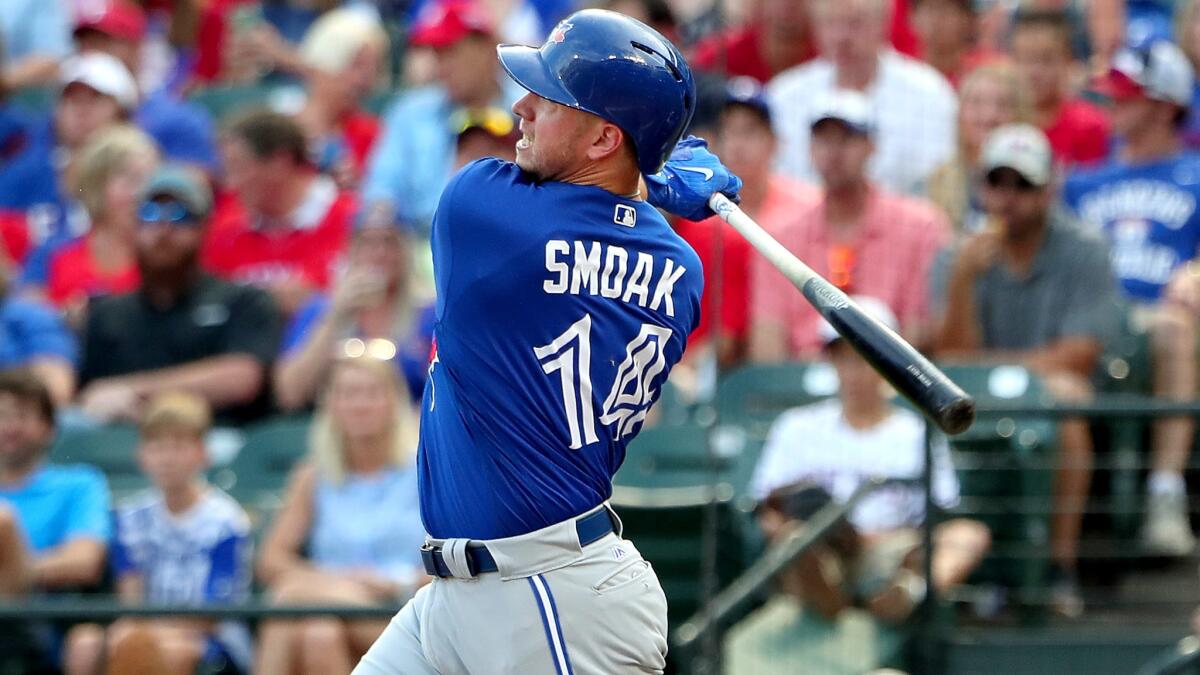 Blue Jays first baseman Justin Smoak follows through on an RBI single against the Rangers earlier this season.