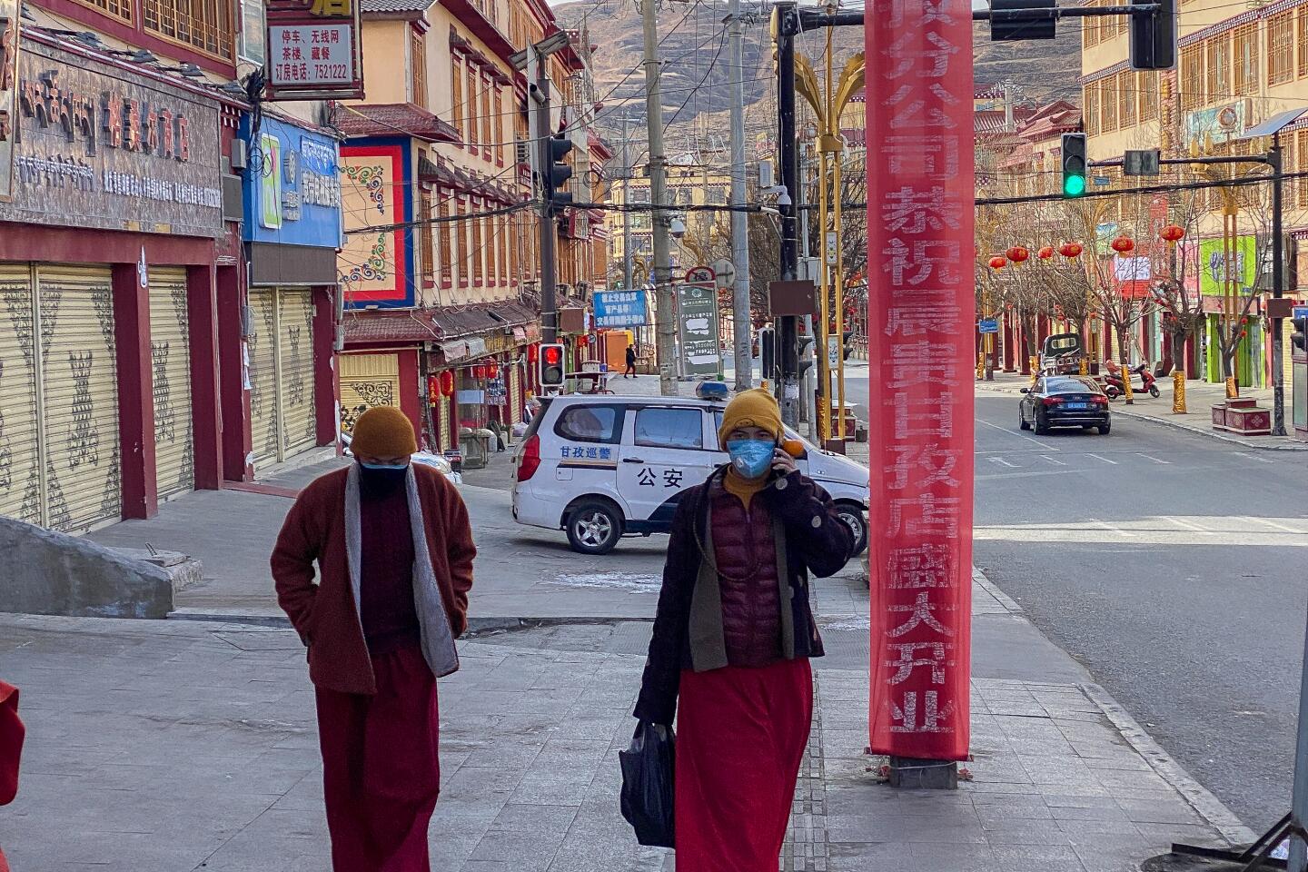 Tibetans wear masks as they walk down a street in Garze on Feb. 8, 2020.