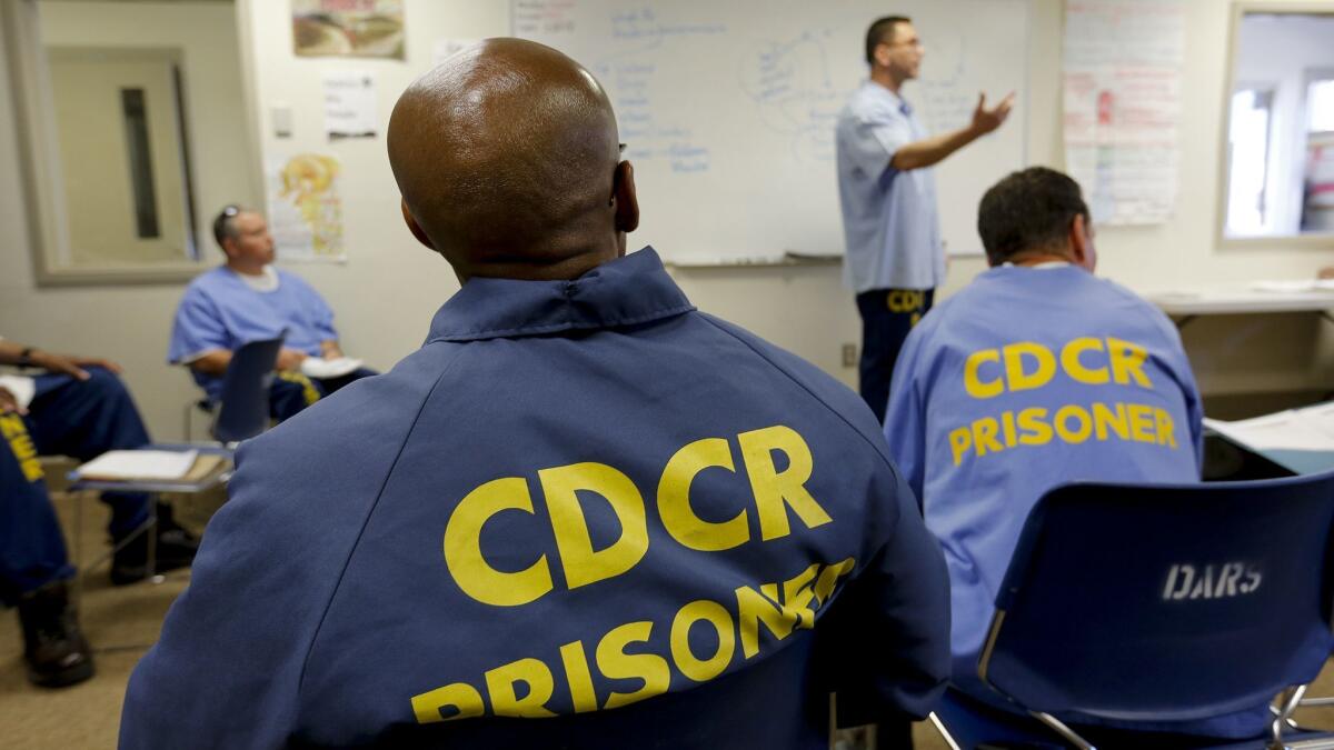 Inmates listen to an instructor during an Offender Mentor Certification Program class at Solano state prison in 2017. The program trains inmates to become substance abuse counselors.