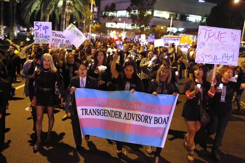 WEST HOLLYWOOD, CA-NOVEMBER 20, 2015: People gathered outside of the West Hollywood Public Library on Friday night to honor Transgender Day of Remembrance. It is a somber annual event where people acknowledge the violence against trans people. Participants took to the streets, marching up San Vicente Blvd. as part of their protest against violence in the LGBT community. (Michael Robinson Chavez / Los Angeles Times)