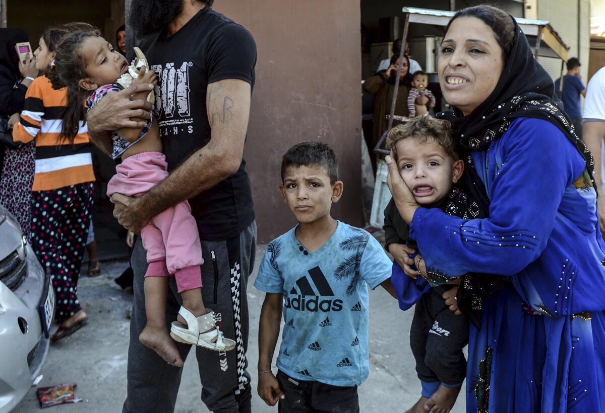 People run to take cover after mortars fired from Syria, in Akcakale, Turkey, Thursday.