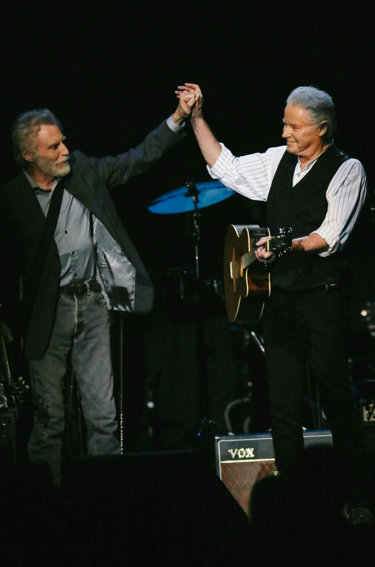 The Eagles' Don Henley high-fives  J.D. Souther