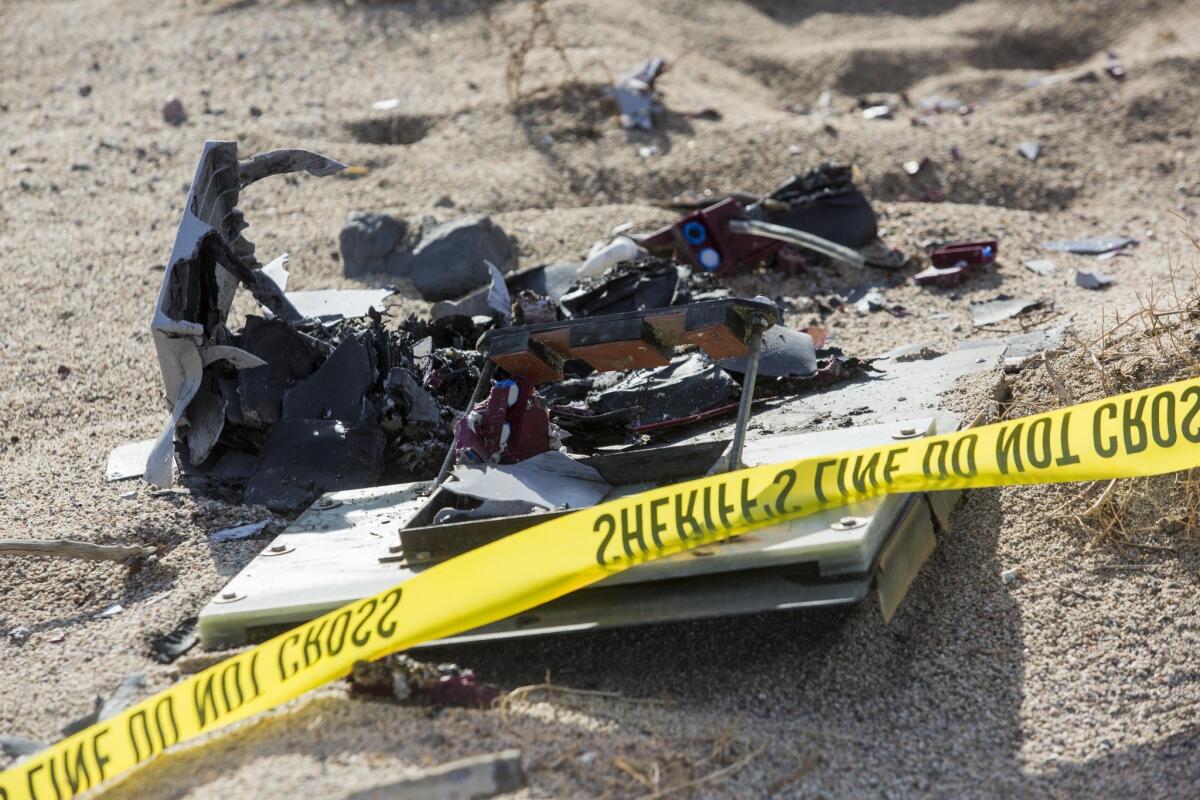 Wreckage lies near the site where a Virgin Galactic space tourism rocket, SpaceShipTwo, exploded and crashed in Mojave, Calif. The explosion killed a pilot aboard and seriously injured another while scattering wreckage in Southern California's Mojave Desert, witnesses and officials said.