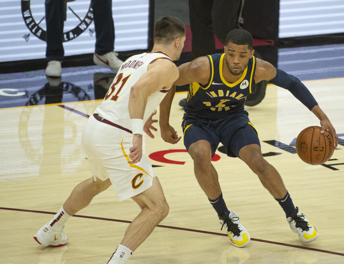 The Indiana Pacers' Cassius Stanley drives past the Cleveland Cavaliers' Matt Mooney.