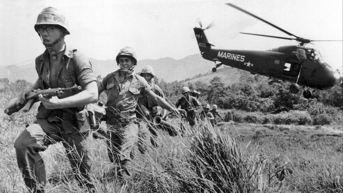 U.S. Marine infantry stream into a suspected Viet Cong village near Da Nang in Vietnam during the Vietnamese war on April 28, 1965.