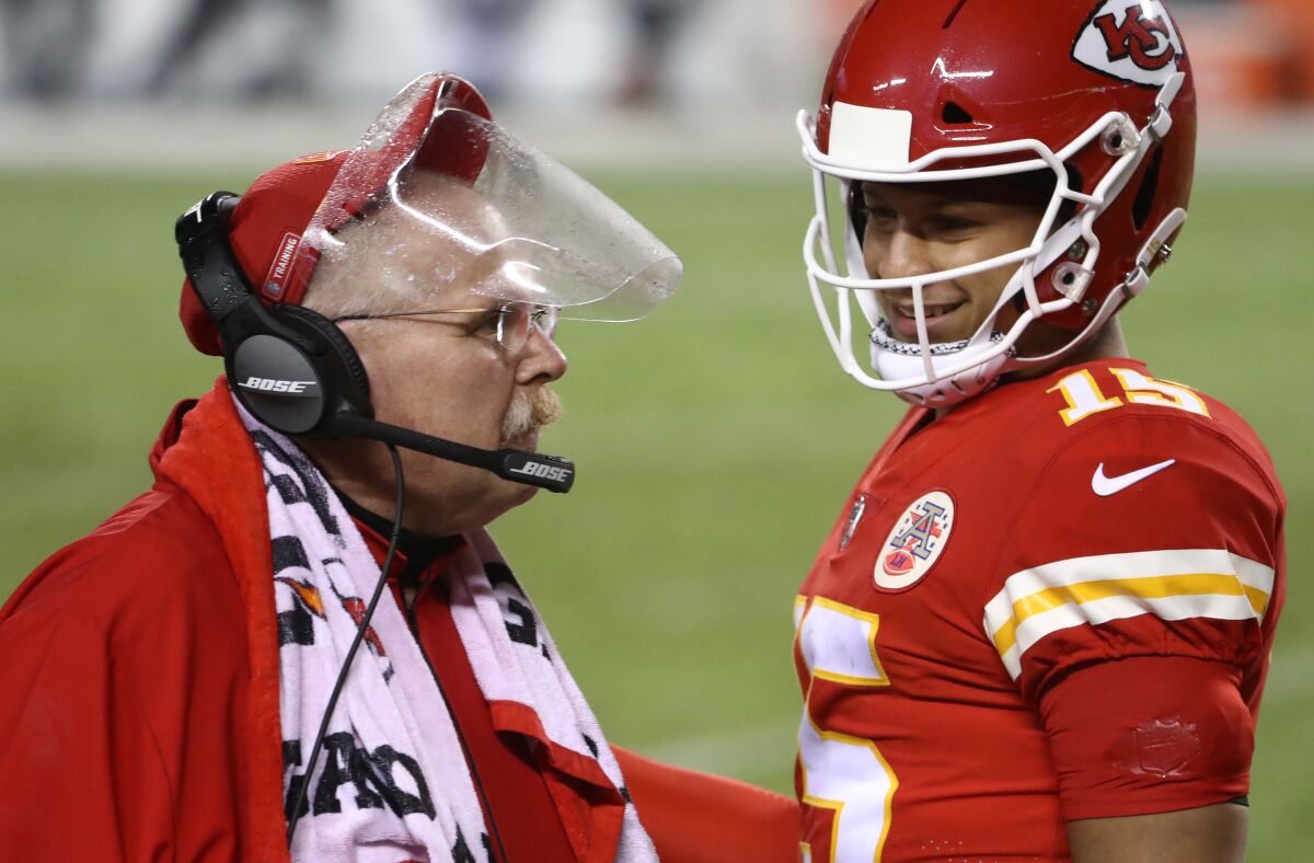 Chiefs coach Andy Reid talks with quarterback Patrick Mahomes during season-opening win Thursday in Kansas City, Mo.