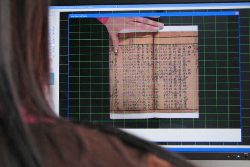 Edith Young, a technician at Harvard University's digital imaging laboratory, scans in "Story of Red Plum Blossom," a Chinese drama written in the Ming Dynasty during the 1600s.