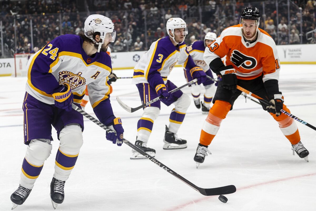 Kings forveti Phillip Danault, Philadelphia Flyers forveti Kevin Hayes'in önünde pakı kontrol ediyor.
