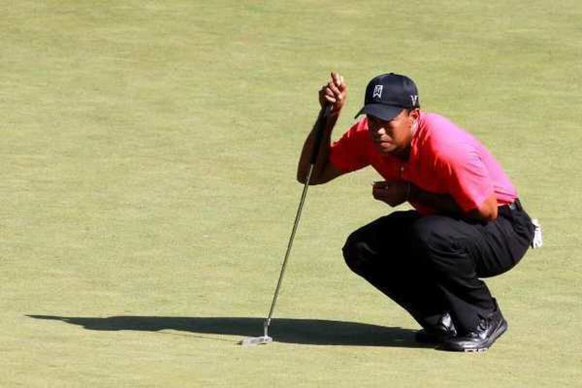Tiger Woods lines up a putt during the final round of the Deutsche Bank Championship.