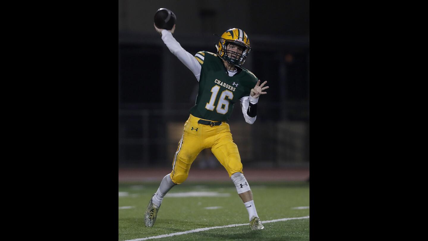 Edison High quarterback Braeden Boyles completes a pass against San Clemente during the first half in a nonleague game at Huntington Beach High on Thursday, Sept. 20.