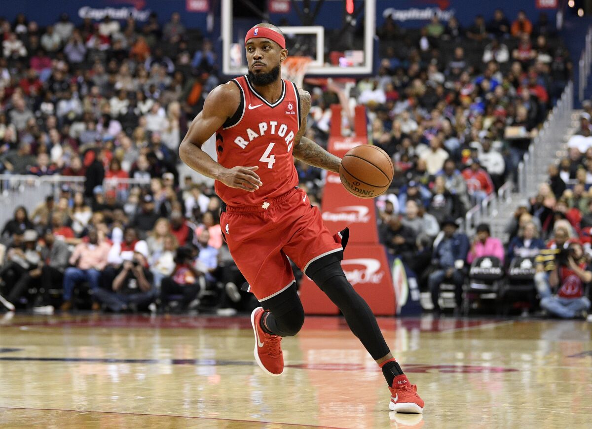 FILE - Toronto Raptors guard Lorenzo Brown (4) dribbles the ball during the first half of an NBA basketball game against the Washington Wizards, Saturday, Oct. 20, 2018, in Washington. Former NBA player Lorenzo Brown has gained Spanish citizenship and is eligible to play for Spain's national team. The Spanish basketball federation welcomed the American player on Tuesday, July 5, 2022, saying his arrival is “part of its strategy to expand the base of players and talent available to play for the national team.” (AP Photo/Nick Wass, File)