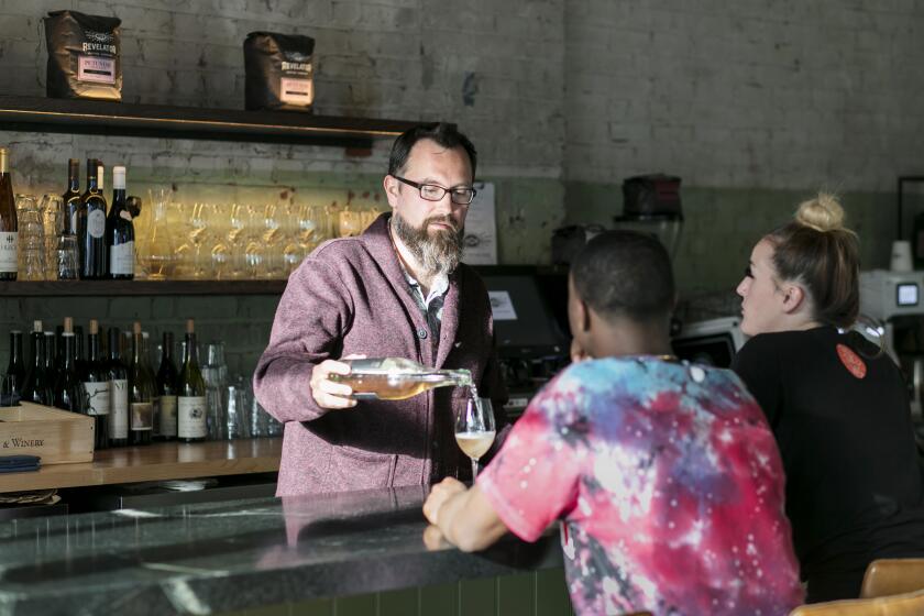 LOS ANGELES, CALIFORNIA - Feb. 28, 2020: Avalon Bar co-owner, the general manager and advanced sommelier Nathaniel Munoz, pours a glass of sparkling rose for customers on Friday afternoon, Feb, 28, 2020, at the restaurant in Echo Park, Los Angeles. (Silvia Razgova / For the Times) Assignment ID: 496644