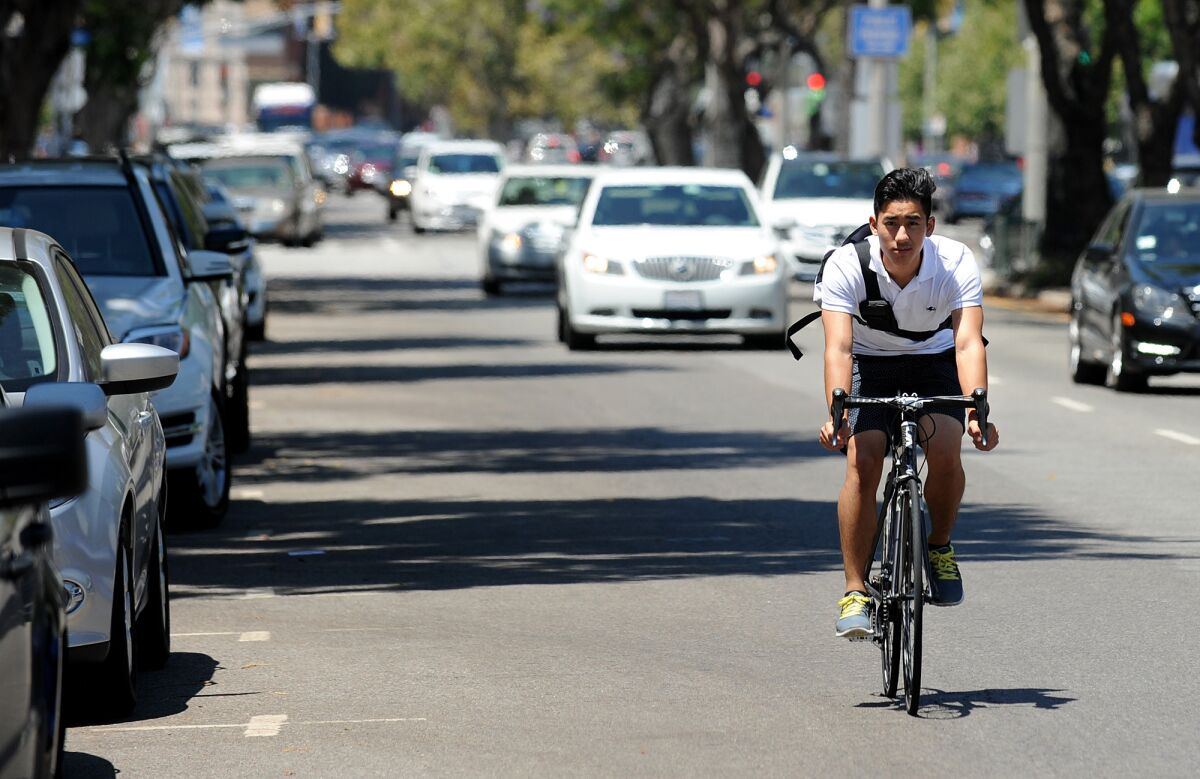 A cyclist rides along Westwood Boulevard in Westwood.