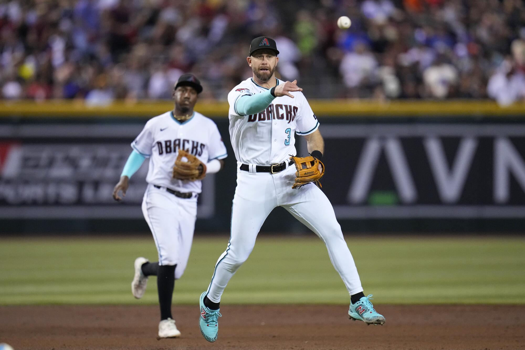 Diamondbacks third baseman Evan Longoria throws to first base against the Houston Astros on Sept. 30, 2023, in Phoenix.