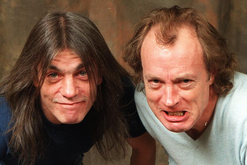 Malcolm Young, left, with brother and AC/DC bandmate Angus Young, has dementia, his family confirmed to People on Tuesday.