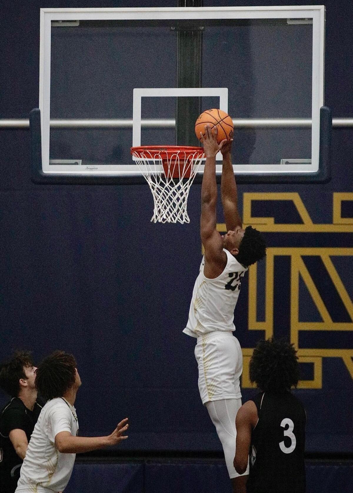 Mercy Miller of Sherman Oaks Notre Dame delivers a dunk. He finished with 33 points against Palisades.