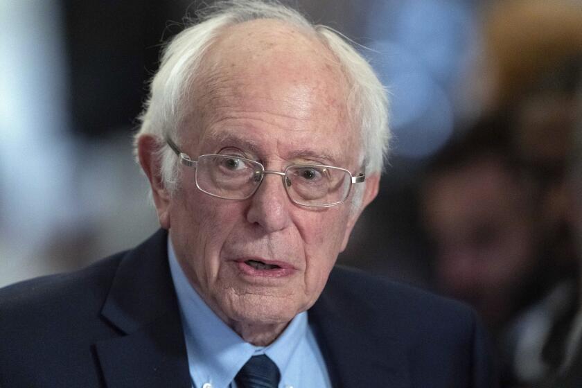 FILE - Sen. Bernie Sanders, I-Vt., talks to the media as he walks to the House chamber before President Joe Biden's State of the Union address at the U.S. Capitol Thursday, March 7, 2024, in Washington. Police in Vermont are seeking a suspect who allegedly started a fire Friday, April 5, 2024, outside the office of U.S. Sen. Bernie Sanders. The small blaze caused minor damage but no injuries. (AP Photo/Jose Luis Magana, File)