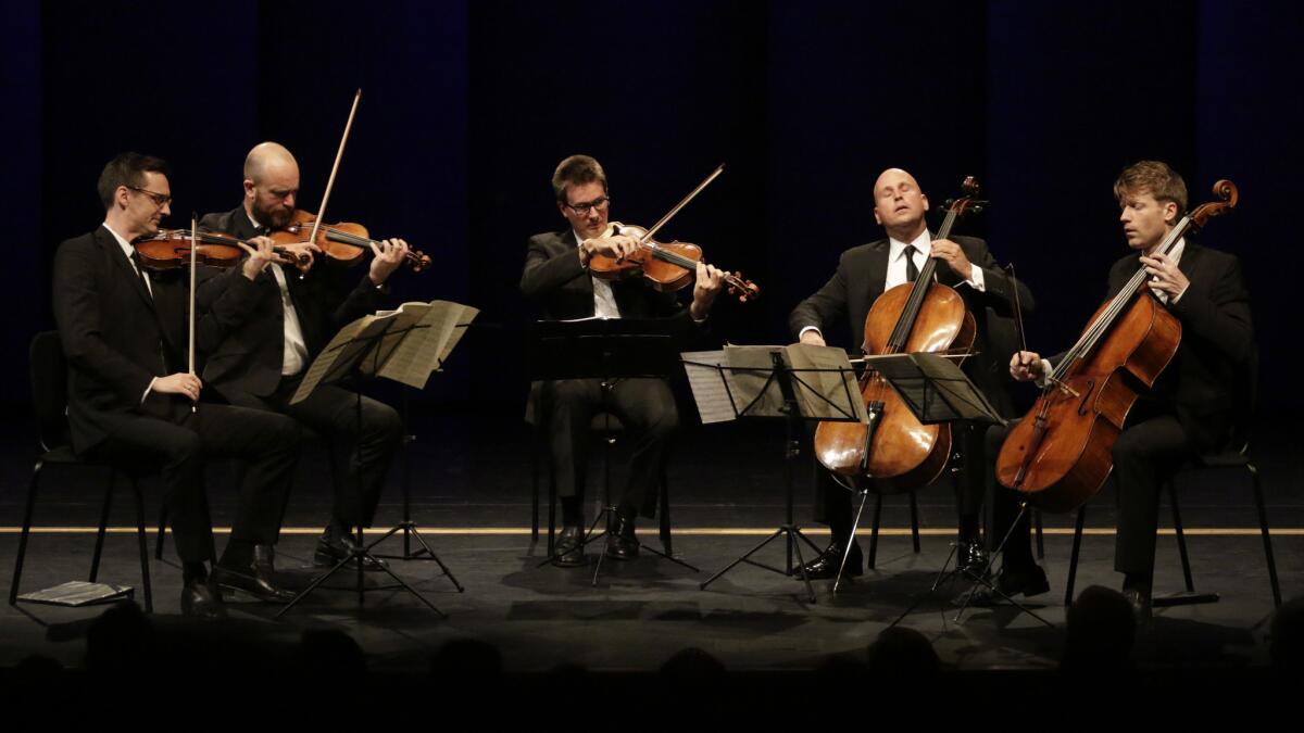 Robert deMaine, second from right, L.A. Philharmonic's principal cellist, joins Calder Quartet's Ben Jacobson, left, Andrew Bulbrook, Jonathan Moerschel and Eric Byers in Schubert's "String Quintet in C" at the Broad Stage in Santa Monica.