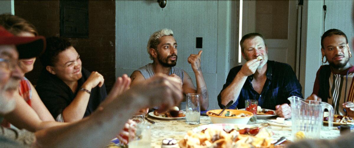 Actors conversing at a dinner table in "Sound of Metal."