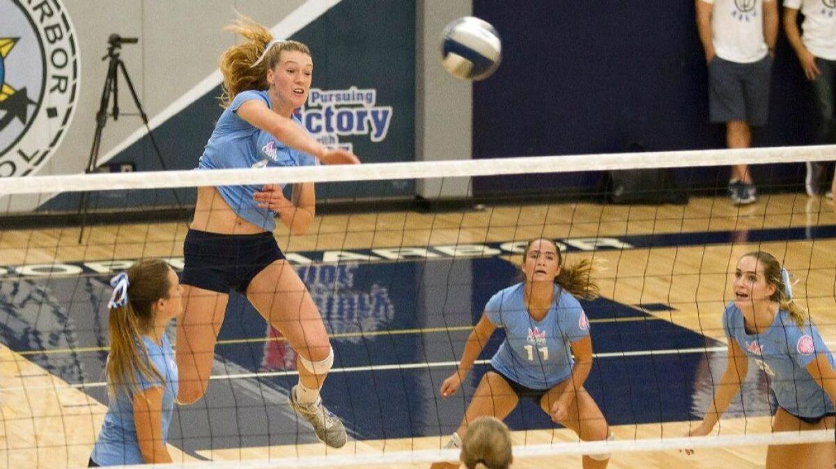 Corona del Mar High's Kendall Kipp attacks a set from Ashley Humphreys (8) in the Battle of the Bay girls' volleyball match against rival Newport Harbor on Sept. 14, 2017. Kipp and Humphreys were named co-MVPs of the Pacific Coast League.