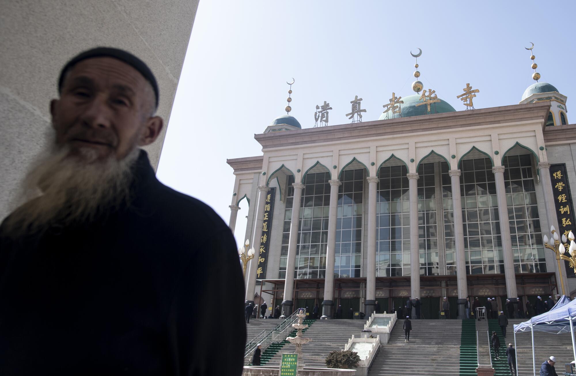 Ethnic Hui Muslim men arriving at Laohuasi Mosque for Friday prayers in Linxia, China's Gansu province. 