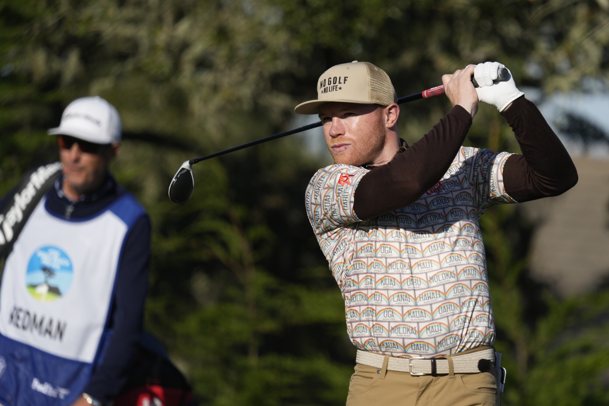 Canelo Alvarez, of Mexico, follows his drive from the second tee of the Monterey Peninsula Country Club Shore Course.