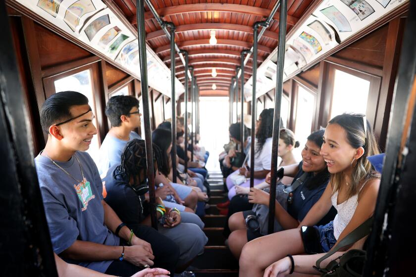 LOS ANGELES-CA-JULY 19, 2024: Participants in The American Exchange Project, a program that sends graduating high school seniors from all over the country to states unlike their own for one week to learn all about that new place and the people in it, ride Angels Flight Railway during a tour of Downtown Los Angeles on July 19, 2024. (Christina House / Los Angeles Times)