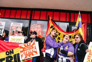 Los Angeles, CA - March 06: Anneisha Williams, third right, Imelda, second right, and Laura Posos, right, chant in support of a three-day strike to protest ongoing wage theft, including the denial of meal breaks, overtime and paid sick leave at Pizza Hut's 2542 W. Temple Street location on Wednesday, March 6, 2024 in Los Angeles, CA. The workers have filed a complaint with the state labor commissioner seeking over $80,000 in back pay and penalties. (Dania Maxwell / Los Angeles Times)