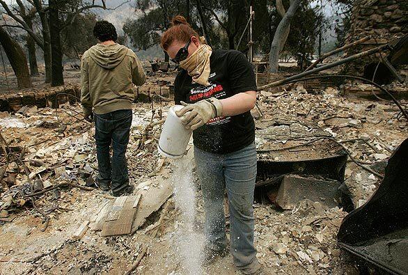 Tiffany Brain searches for anything of value of what's left after the Station fire destroyed her uncle's home in Big Tujunga Canyon.