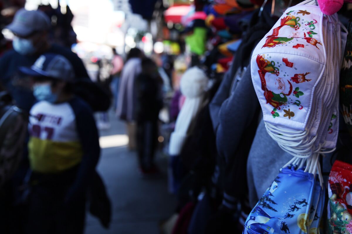 Masks are sold in downtown Los Angeles on Tuesday, the same day California extended regional stay-at-home orders.